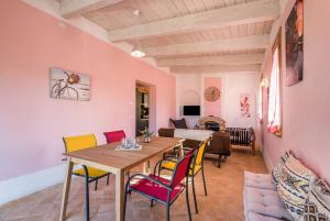a living room with a wooden table and chairs at Chalet Cigno - Apartment in Tuscany in Osteria Delle Noci