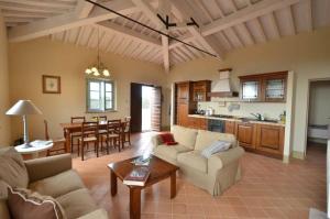a living room with two couches and a table at Quercia Apartment - Cignella Resort Tuscany in Osteria Delle Noci