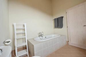 a bathroom with a sink and a bath tub at Quercia Apartment - Cignella Resort Tuscany in Osteria Delle Noci +26 photos