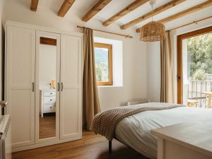 a bedroom with a bed and a window at Casa espaiosa amb llar de foc in Ribes de Freser +37 photos