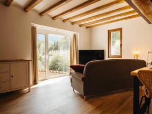 a living room with a couch and a large window at Casa espaiosa amb llar de foc in Ribes de Freser