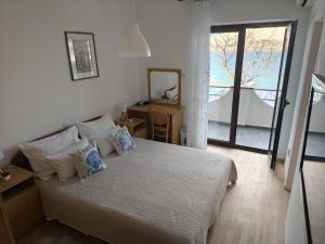 a bedroom with a bed and a mirror and a window at Hotel Biser in Pag +96 photos