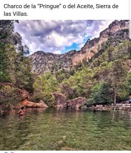 a person swimming in a river in a canyon at Refugio Ruta Río Borosa in Coto Ríos +16 photos