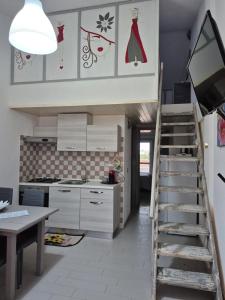 a kitchen with a staircase leading up to a kitchen at Casa Elias in Orosei
