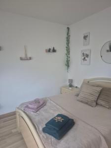 a bedroom with a bed with two towels on it at Chez Vallye in Maxent