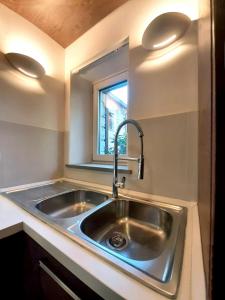 a kitchen with a sink and a window at Il Cortile delle magnolie in Gubbio +32 photos