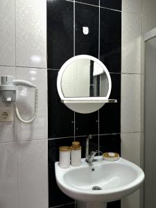 a bathroom with a white sink and a mirror at Avcılar İnci Hotel in Istanbul