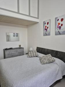 a bedroom with a bed with two pillows on it at Casa Elias in Orosei
