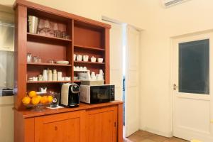 a kitchen with a cabinet with a microwave and oranges on it at Antica Dimora Caruso in Catania