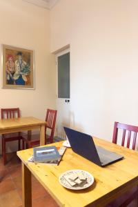 a wooden table with a laptop on top of it at Antica Dimora Caruso in Catania +45 photos