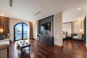 a living room with a couch and a table at Mira Boutique Hotel Quy Nhon in Quy Nhon