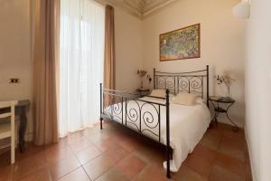 a bedroom with a black bed in a room at Antica Dimora Caruso in Catania