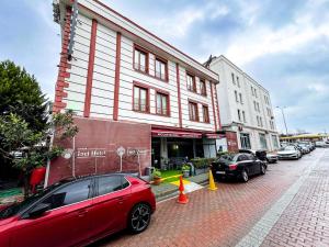 a red car parked in front of a building at Avcılar İnci Hotel in Istanbul