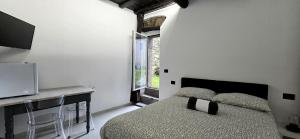 a bedroom with a bed and a desk and a television at Cinque Terre Homes by Bluchalet in Riomaggiore