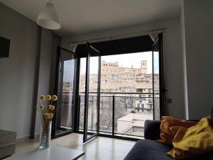 a living room with a large window with a view at Apartamentos La Aubaga in Valderrobres