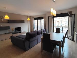 a living room with a couch and a table at Apartamentos La Aubaga in Valderrobres +12 photos