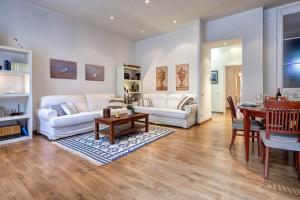 ein Wohnzimmer mit 2 weißen Sofas und einem Tisch in der Unterkunft Habitat Apartments Bruc Terrace in Barcelona