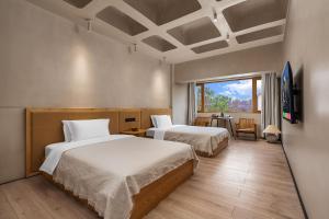 Vuode tai vuoteita majoituspaikassa Kunming Latosol hotel
