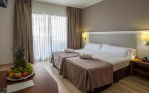 Postel nebo postele na pokoji v ubytování Rosamar & Spa 4*s