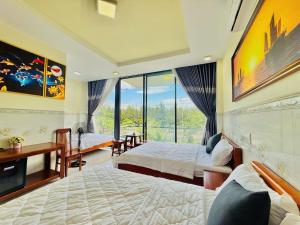 a bedroom with two beds and a large window at New Day Tuy Hòa in Liên Trì (4)