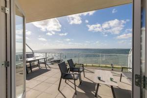 a balcony with a view of the ocean at Welcome in - Royaal appartement 'De Zeester' met riant terras I Gorishoeksedijk 41, Scherpenisse in Scherpenisse
