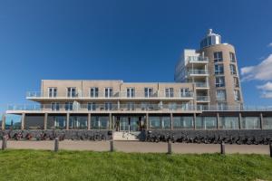 a building with a bunch of bikes parked in front of it at Welcome in - Royaal appartement 'De Zeester' met riant terras I Gorishoeksedijk 41, Scherpenisse in Scherpenisse +62 photos