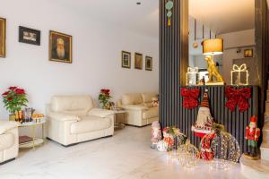 a living room with two couches and christmas decorations at Hotel Boutique Tunari in Tunari