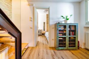 a room with a book shelf with books at Torretta In Centro Perugia in Perugia