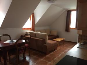 a living room with a couch and a table at Batthyány Villapark in Zalacsány +9 photos