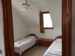 a room with two beds and a window at Batthyány Villapark in Zalacsány