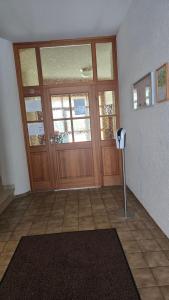 a room with a large wooden door with a parking meter at PensionSchilling in Grasbrunn
