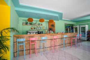 a bar with pink and blue bar stools at Maui Poolside Studios in Laganas +17 photos