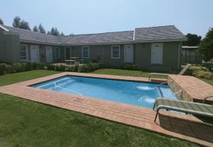 a swimming pool in the yard of a house at Eagle Cove in Honeydew