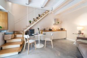 a kitchen and a living room with a table and chairs at Le Vie del Borgo | 3 dimore indipendenti a Civita in Civita