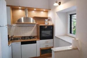 a small kitchen with a stove and a sink at A due passi dal Teatro Massimo in Palermo +12 photos