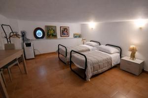 a bedroom with two beds and a table in it at A due passi dal Teatro Massimo in Palermo