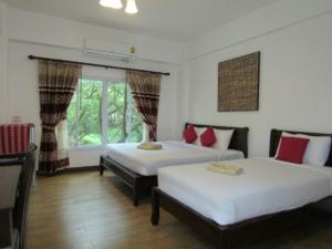 Postel nebo postele na pokoji v ubytování รีสอร์ทที่ลำปาง (Resort At Lampang)