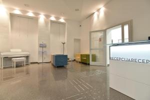 a room with a white piano and a desk at SC Pula Rooms & Studio in Pula