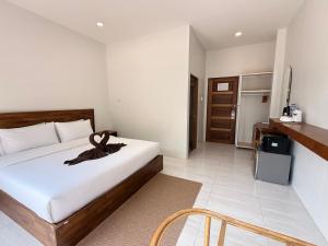 a hotel room with a bed and a kitchen at Chailai room202 in Ban Sai Thai