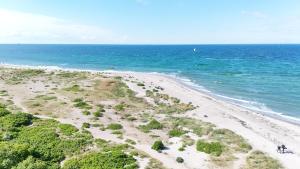 an aerial view of a beach with the ocean at Bauernhuus 5 in Fehmarn
