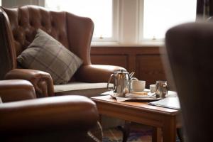 a living room with a coffee table and a couch at Loch Awe Hotel in Dalmally