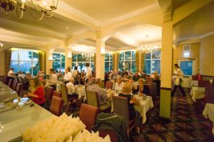 a group of people sitting at tables in a restaurant at Loch Awe Hotel in Dalmally +11 photos