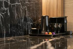 a black marble counter top with a coffee maker on it at Blanq Gran vía in Valencia