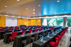 a conference room with tables and red chairs at Alexandre Fira Congress in Hospitalet de Llobregat +40 photos