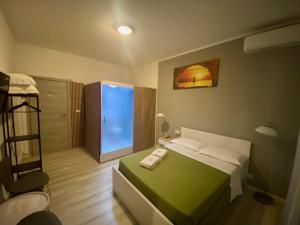a small bedroom with a bed and a room with a shower at Guest House Pirelli Milano in Milan