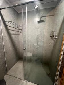 a shower with a glass door in a bathroom at Hotel Eleven in Kathmandu +18 photos
