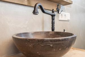 a sink in a bathroom with a faucet at Schaapskooi in Maarsbergen