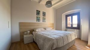 a white bedroom with a large bed and a window at Appartamento indipendente apt 4 in Piadena
