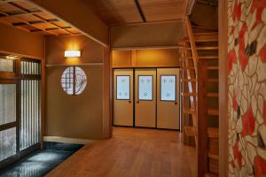 a hallway with two doors and a spiral staircase at 修善寺あざみ Luxury Japanese Villa with Mt Fuji Views and Onsen in Izu +39 photos