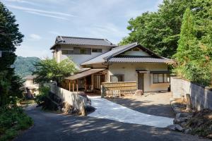a house with a driveway in front of it at 修善寺あざみ Luxury Japanese Villa with Mt Fuji Views and Onsen in Izu